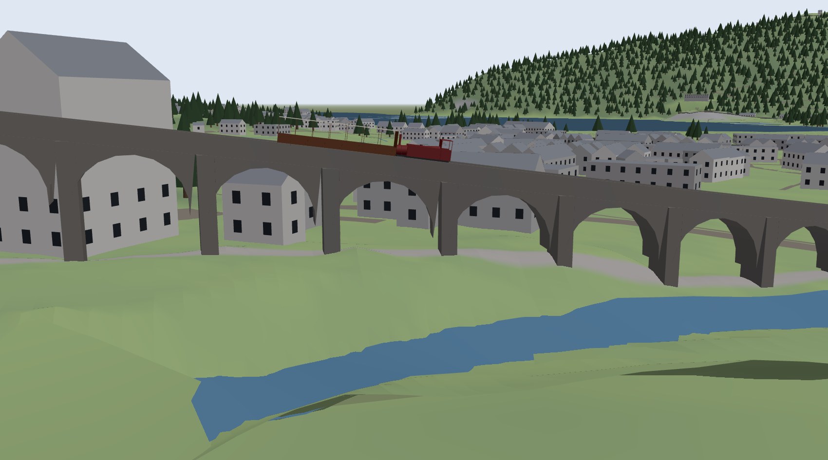 The Snowdon train crossing the lower viaduct on its stone arches, with the river below and Llanberis behind