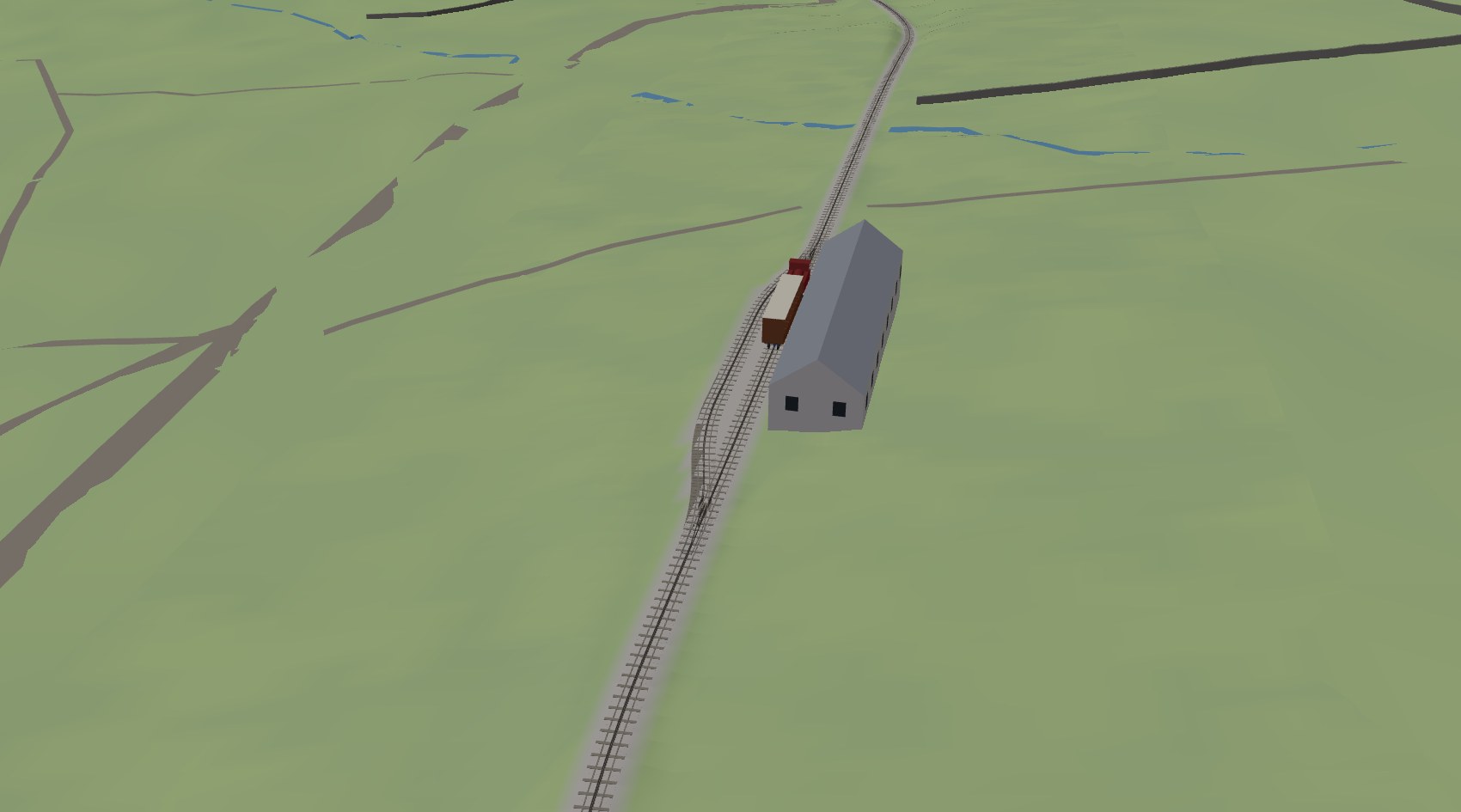 The passing loop at Hebron seen from above, with the train in the loop beside the station building